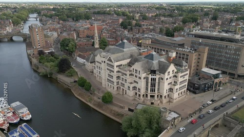 Pullback Establishing Aerial Drone Shot Revealing View Down River Ouse with Old Bridges in York City Centre with 2 Man Boat Rowing Down River photo