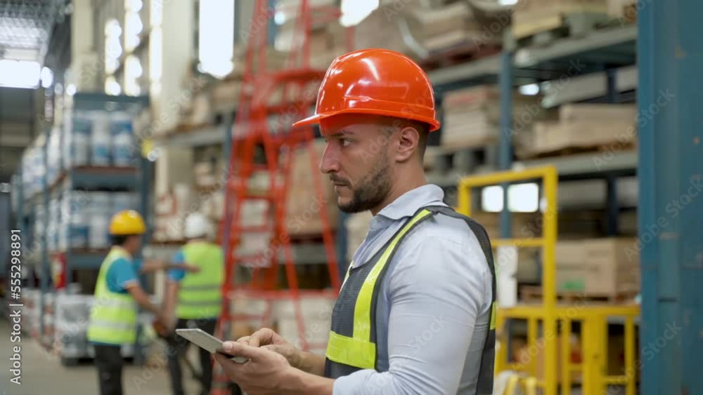 4K, Warehouse keeper is counting items on the shelf through tablet in hand. Count before sending to customer. Factory workers in safety suits and helmets use laptops in the middle of a warehouse. 4K, Warehouse keeper is counting items on the shelf through tablet in hand. Count before sending to customer. Factory workers in safety suits and helmets use laptops in the middle of a warehouse.