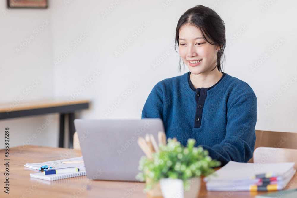 Business Asian woman Using laptop computer and working at office with calculator document on desk, doing planning analyzing the financial report, business plan investment, finance analysis concept. Business Asian woman Using laptop computer and working at office with calculator document on desk, doing planning analyzing the financial report, business plan investment, finance analysis concept.