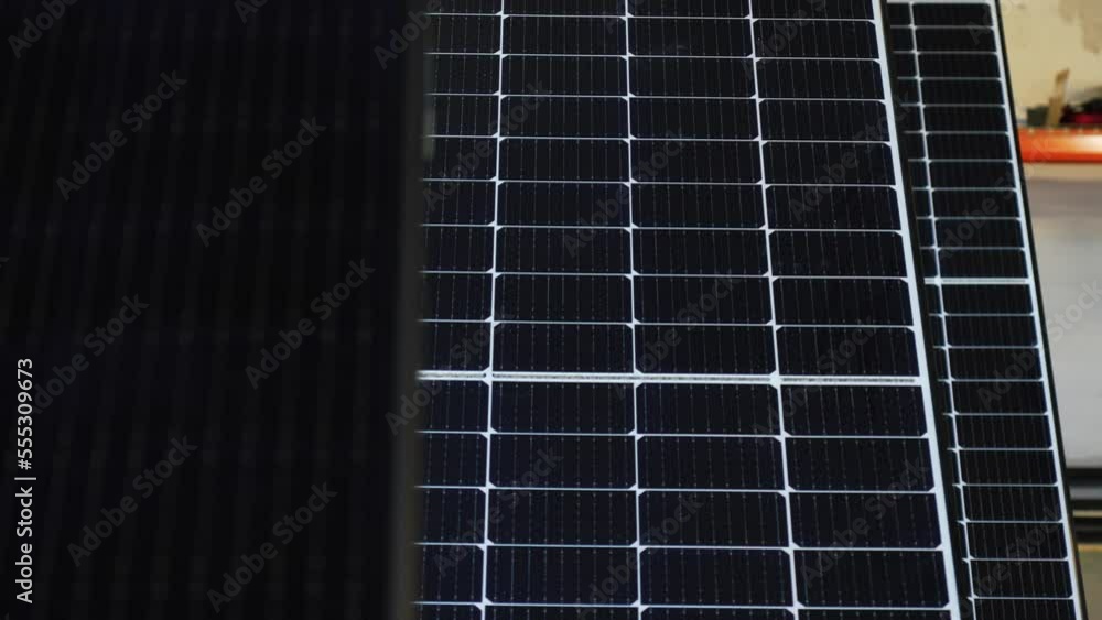 Aerial panning shot of solar panels on rooftop during sunny day - modern technology Aerial panning shot of solar panels on rooftop during sunny day - modern technology