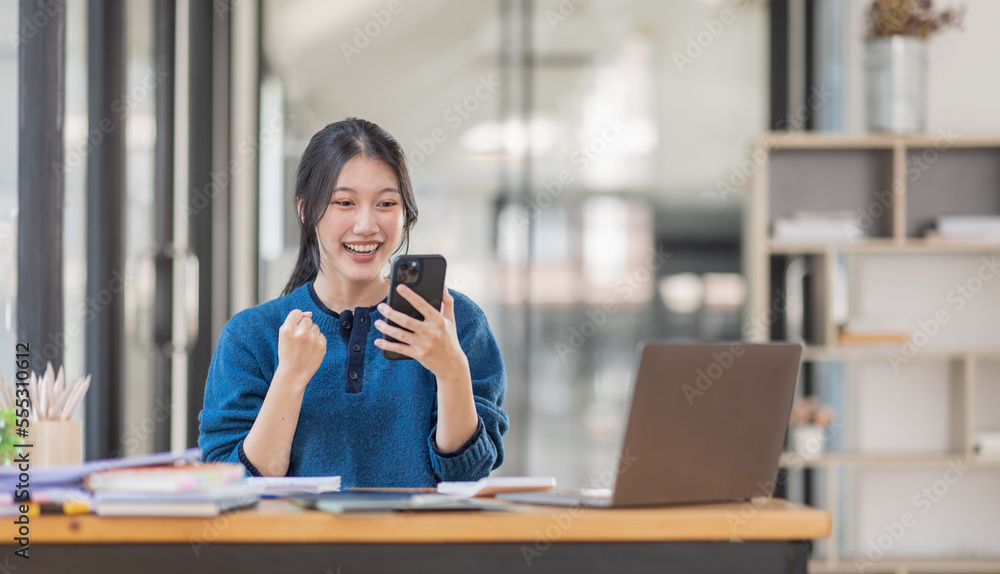 Image of a happy excited young entrepreneur Asian woman in workplace, winner, feel excited, Happy, joyful, Surprised and business finance concept. Image of a happy excited young entrepreneur Asian woman in workplace, winner, feel excited, Happy, joyful, Surprised and business finance concept.