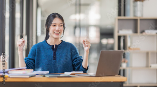 Image of a happy excited young entrepreneur Asian woman in workplace, winner, feel excited, Happy, joyful, Surprised and business finance concept.