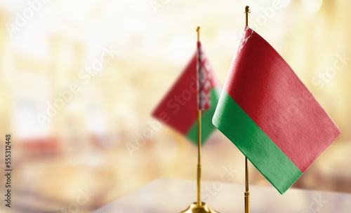 Small flags of the Belarus on an abstract blurry background photo