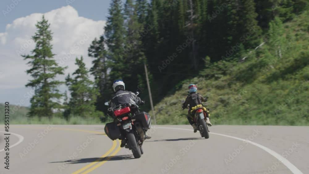 Tracking shot behind Adventure motorcycle riders on two lane paved road in Steamboat Colorado Tracking shot behind Adventure motorcycle riders on two lane paved road in Steamboat Colorado