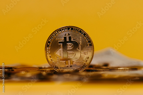 golden bitcoin coin with yellow background