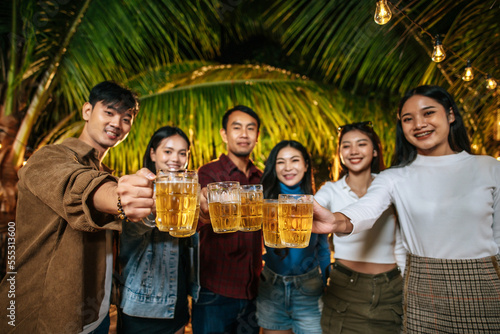 Portrait of Happy Asian friends having dinner party together - Young people toasting beer glasses dinner outdoor  - People  food  drink lifestyle  new year celebration concept.