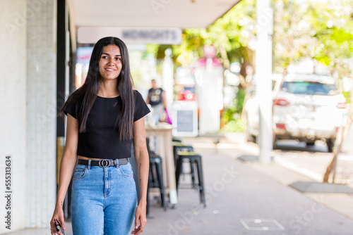 happy aboriginal woman walking in an urban setting photo