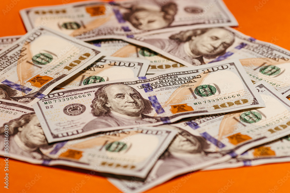 100 dollar bill with orange background 100 dollar bill with orange background