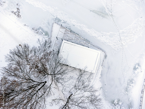 Aerial view. Winter landscape, snow, frost, ice, trees, alleys and paths, park. Sharp winter. 