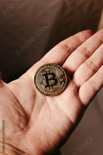 hands holding golden cryptocurrencies