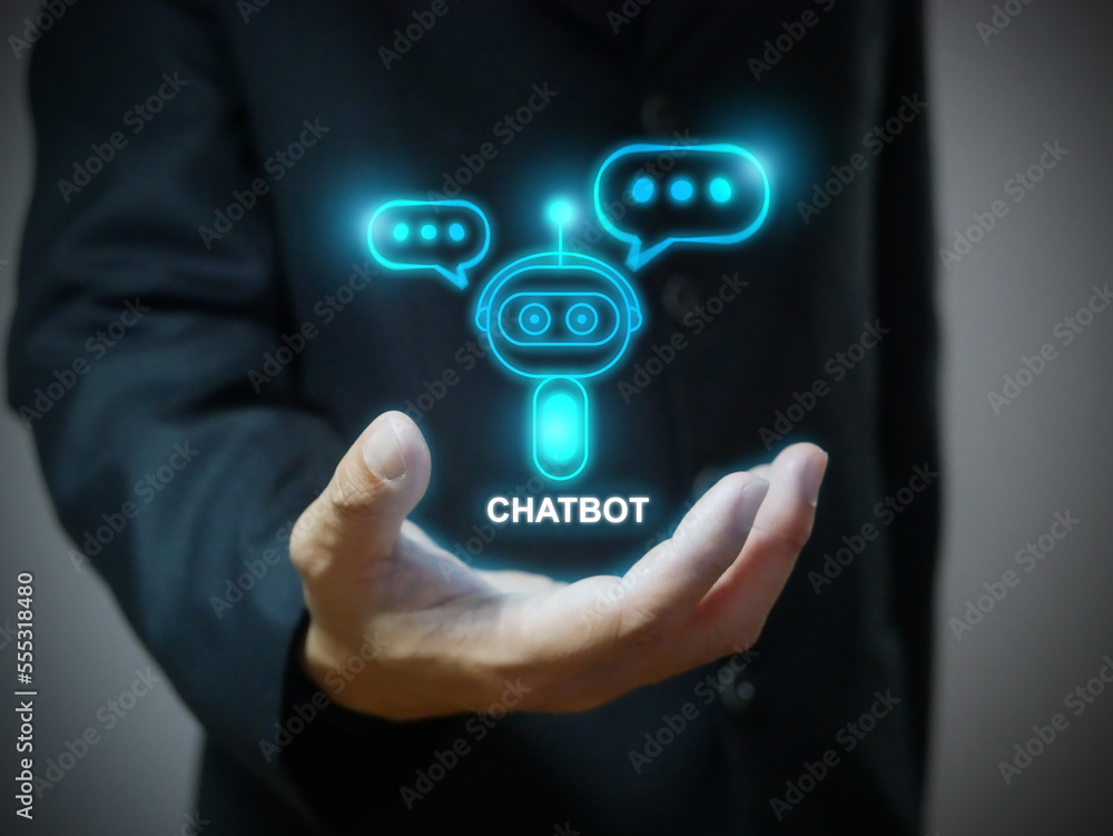A hand holding digital chatbot that conducting an online chat conversation and provide information. Chatterbot application, AI, Artificial intelligence, global connection, innovation and technology A hand holding digital chatbot that conducting an online chat conversation and provide information. Chatterbot application, AI, Artificial intelligence, global connection, innovation and technology