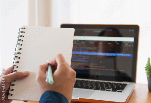 Programer developer coding software about intelligence innovation. Young man programmer writes program code on a computer. home office .