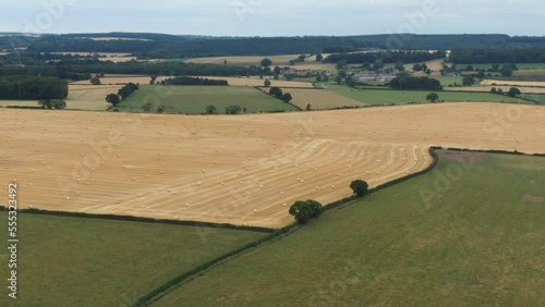 Drone shot of field full of hay bales after harvest in yorkshire england surrounded by fields in the countryside photo