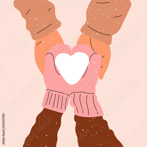 Hands in mittens hold a heart made of snow. Love, Valentine's Day.	