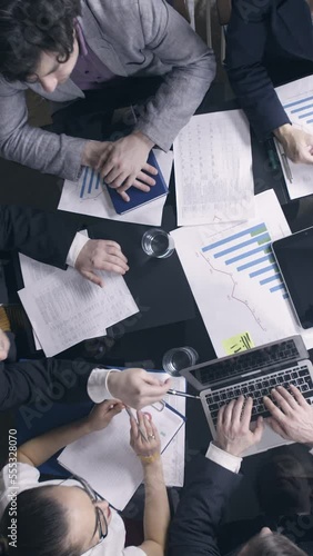 Top view of business people in the meeting room.. Vertical video