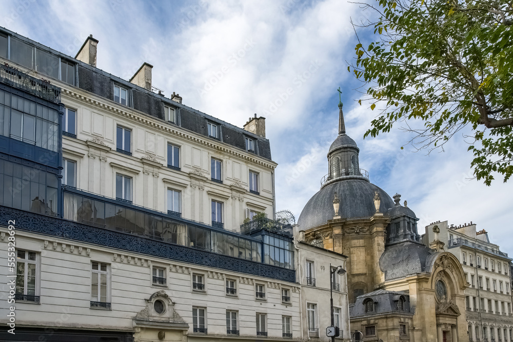 Paris, typical buildings in the Marais, rue Saint-Antoine, with the Saint-Paul church
