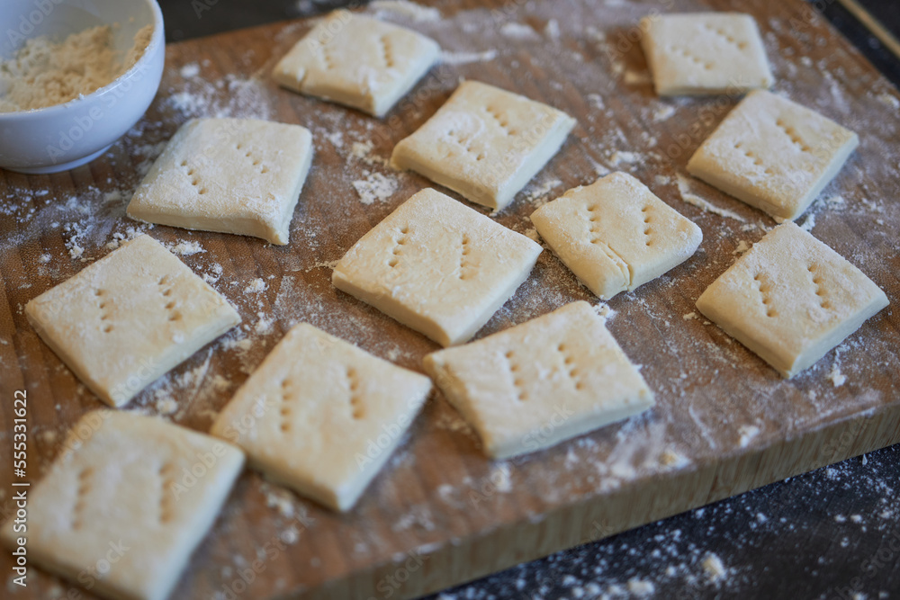 Making homemade cookies - crackers. Preparing cookies for baking.
Making homemade cookies - crackers. Preparing cookies for baking.