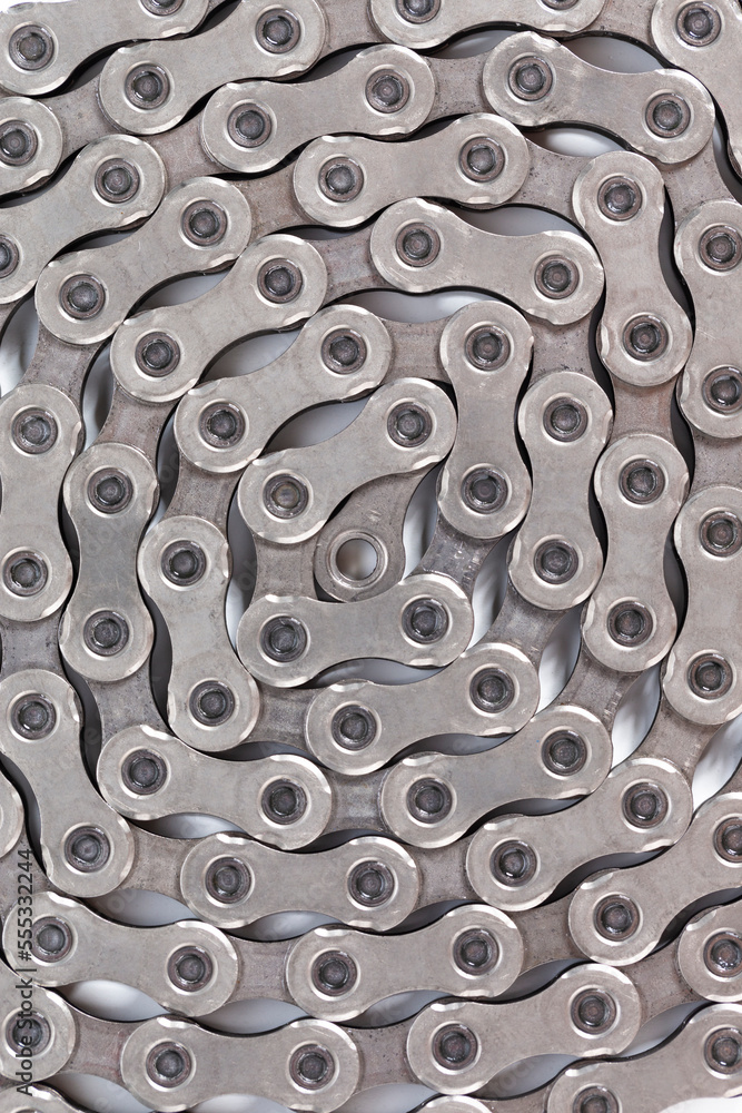 Closeup Of New Clean Oiled Twisted Circled Bicycle Chain Image Texture Isolated Over White Background. Closeup Of New Clean Oiled Twisted Circled Bicycle Chain Image Texture Isolated Over White Background.