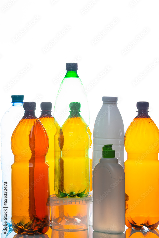 Various Empty Colorful Plastic Recycle Garbage Bottles and Cans In Line Together Over White Background. Various Empty Colorful Plastic Recycle Garbage Bottles and Cans In Line Together Over White Background.