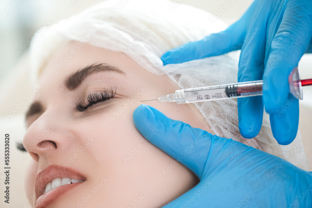 Closeup of Cosmetologist Hand While Injections Process for Lips, Eyelashes and Skin Augmentation For Anti Wrinkle For Young Female Caucasian Woman in Beauty salon Closeup of Cosmetologist Hand While Injections Process for Lips, Eyelashes and Skin Augmentation For Anti Wrinkle For Young Female Caucasian Woman in Beauty salon