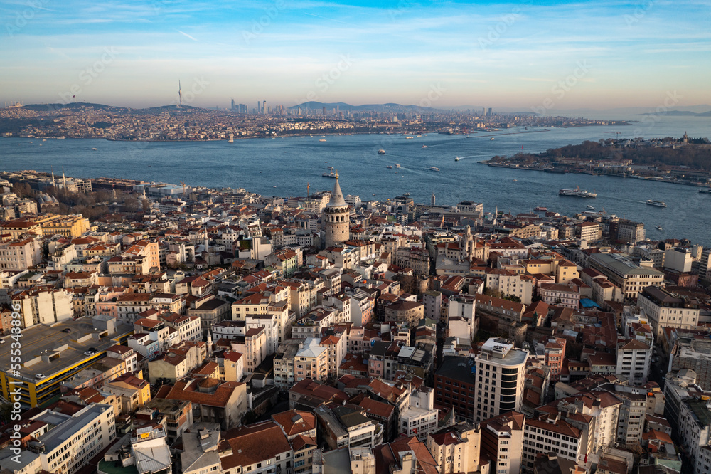 Aerial evening shot of the Galata Tower in Istanbul, Turkey. Aerial view of landmark at golden hour with beautiful sunlight.