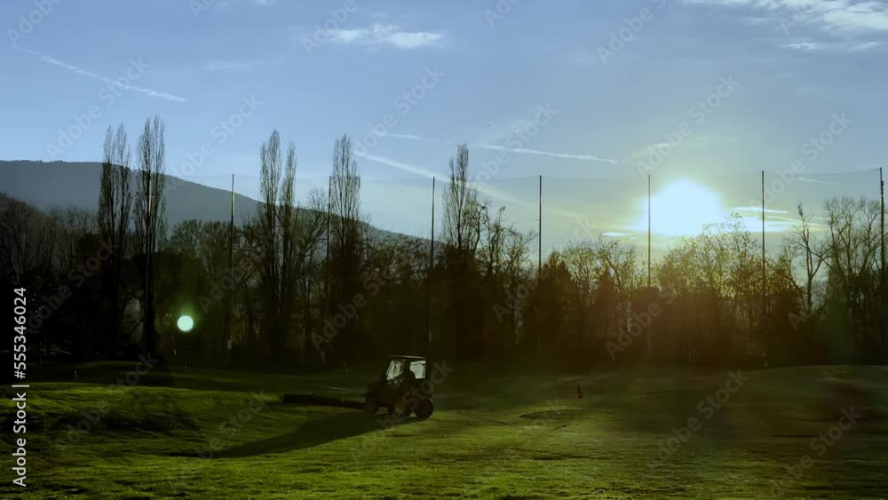 Golf Ball Retrieval Machine at Driving Range with Sunlight and Lens