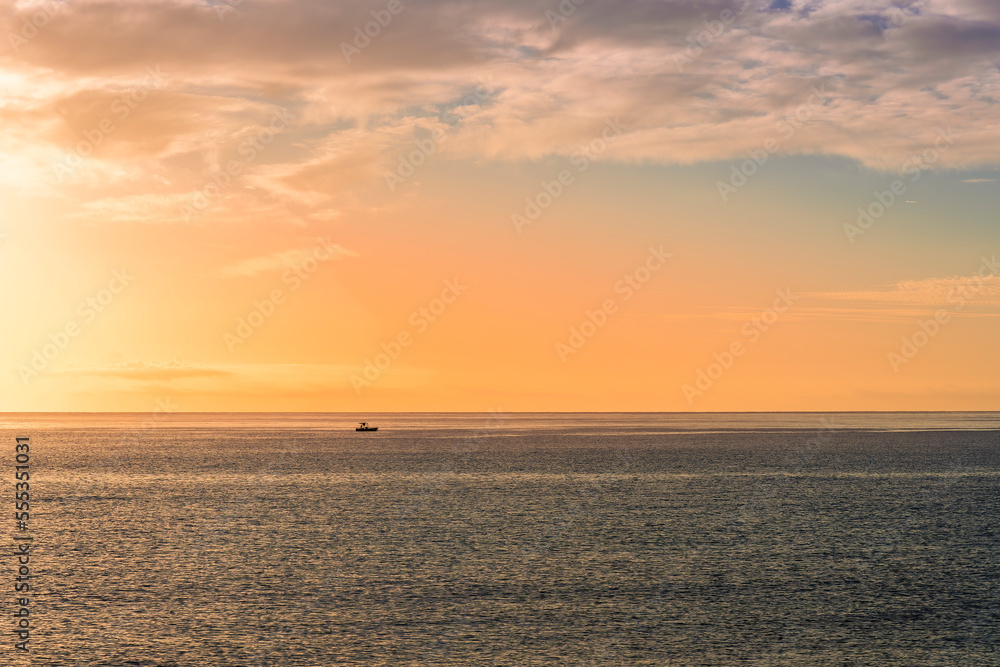 view at sunrise or sunset in sea with nice beach , surf , calm water and beautiful clouds on a background of a sea landscape