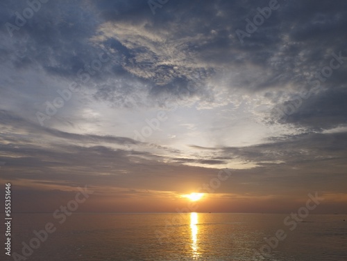 Dark light, dark sky, sunset in the evening, sunrise in the morning by the sea. Soft sunlight through the clouds. Idea for travel, vacation, meditation, peace, summer, relaxation. in Thailand