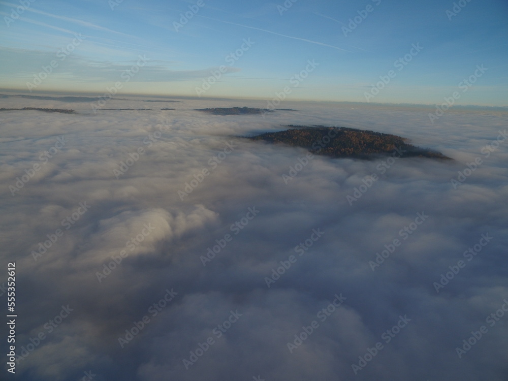 flight above clouds through the cloudy sky