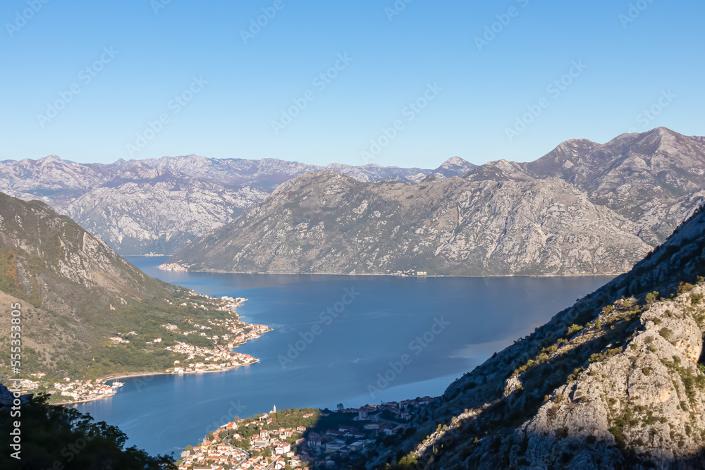 Panoramic view of the bay of Kotor during sunrise in summer, Adriatic Mediterranean Sea, Montenegro, Balkan Peninsula, Europe. Fjord winding along the coastal towns. Lovcen and Orjen mountain range