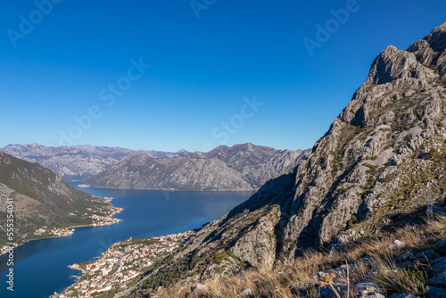 Panoramic view of the bay of Kotor during sunrise in summer, Adriatic Mediterranean Sea, Montenegro, Balkan Peninsula, Europe. Fjord winding along the coastal towns. Lovcen and Orjen mountain range