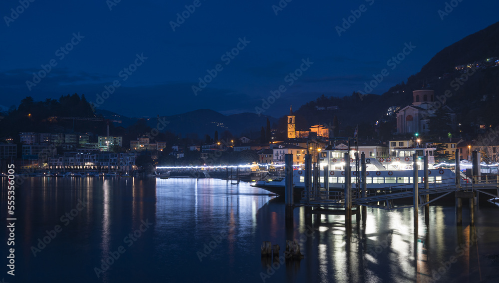 Night panorama of the lakefront of Laveno illuminated by many colored Christmas lights