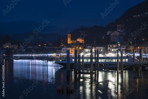 Night panorama of the lakefront of Laveno illuminated by many colored Christmas lights