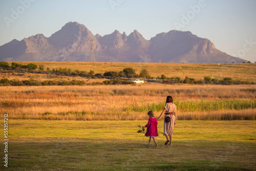 a girl with a child on the background of the mountains of the South African republic
