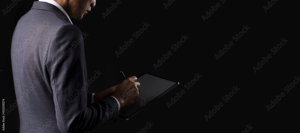 Businessman working with modern digital tablet. Concepts of working anywhere, compliance, policies, data encryption Businessman working with modern digital tablet. Concepts of working anywhere, compliance, policies, data encryption