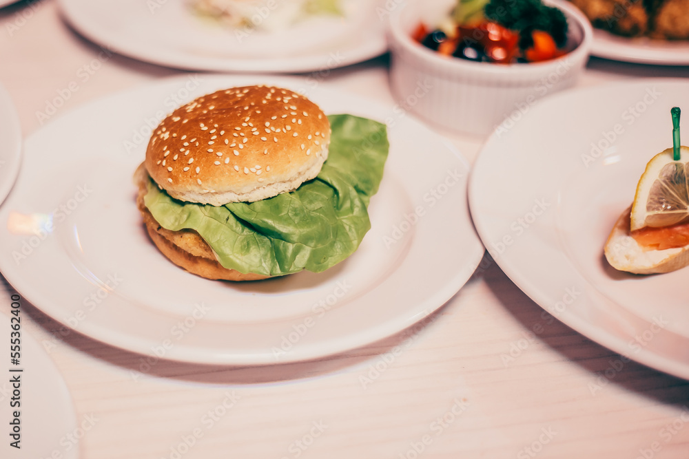 hamburger and other dishes on the table in the restaurant hamburger and other dishes on the table in the restaurant