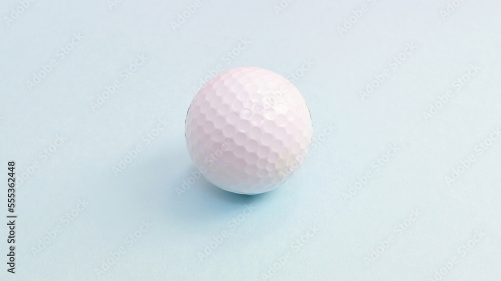 Golf ball, sports equipment isolated on blue background Golf ball, sports equipment isolated on blue background