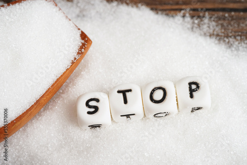 STOP, sweet granulated sugar with text, diabetes prevention, diet and weight loss for good health.