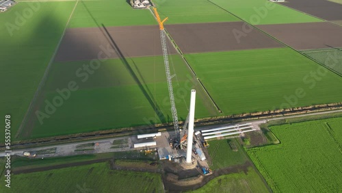 Construction site of a wind turbine windmill. Green energy generation in The Netherlands. Sustainable energy transistion in the making. Aerial drone view. Build using cranes. Green electric energy. photo