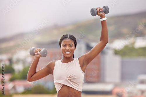 Fitness, portrait and woman weightlifting with dumbells for bodybuilding and strong arms. Face, front and african american female bodybuilder exercising or training for strength in the city