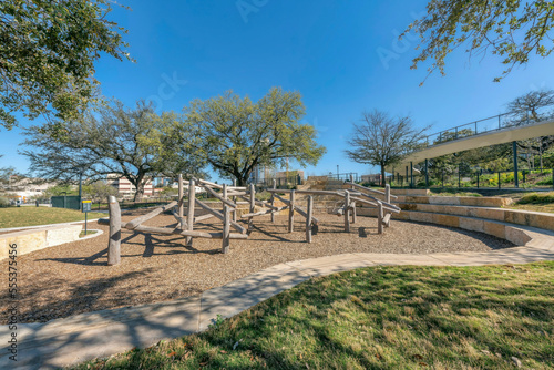 Austin, Texas- Waterloo Park playground with wood logs structure with hanging net