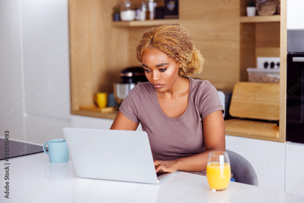 Woman having breakfast and working remotely from home Woman having breakfast and working remotely from home