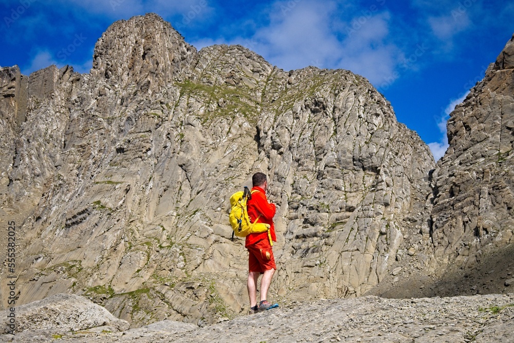 A man hikes the trail to Balcon de Pineta, a popular route in the Spanish Pyrenees A man hikes the trail to Balcon de Pineta, a popular route in the Spanish Pyrenees