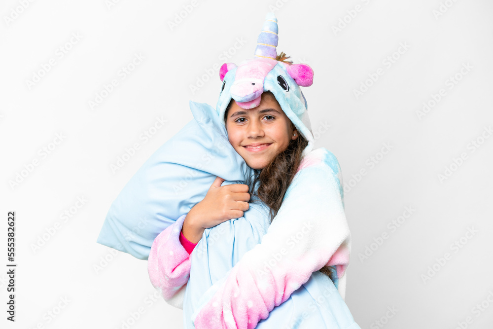 Girl with unicorn pajamas over isolated white background Girl with unicorn pajamas over isolated white background