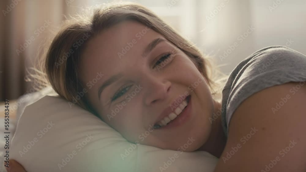 Caucasian woman lying in bed at morning and looking at camera. Shot with RED helium camera in 8K. Caucasian woman lying in bed at morning and looking at camera. Shot with RED helium camera in 8K.
