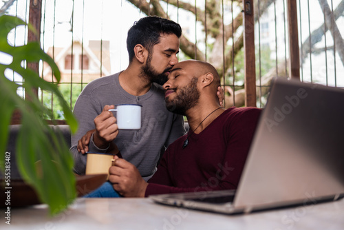 intimate gay couple moment, enjoying a cup of coffee at home