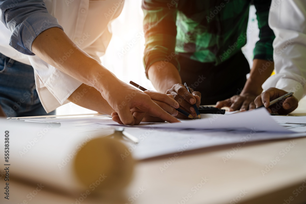 architect or engineer team working on table use drawing tool on the paper plan for business architectural project. architect or engineer team working on table use drawing tool on the paper plan for business architectural project.