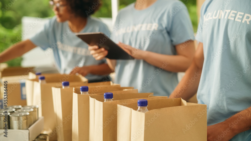 Close Up Footage of a Group of Volunteers Preparing Free Food Rations ...