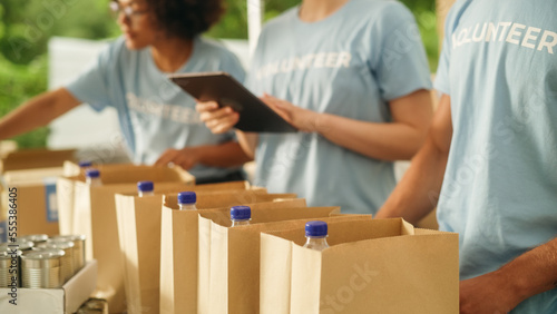 Canvastavla Close Up Footage of a Group of Volunteers Preparing Free Food Rations for Poor People in Need