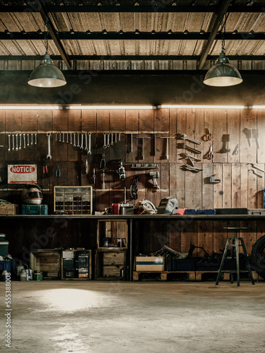 Workshop scene. Old tools hanging on wall in workshop  Tool shelf against a table and wall  vintage garage style